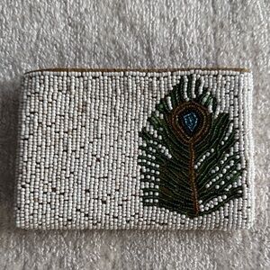 Elegant White Beaded Clutch with Peacock Feather Design
